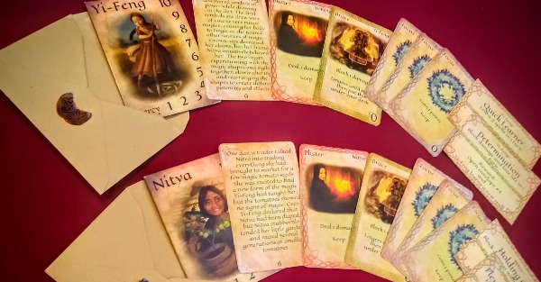 Two open envelopes with the starting cards of Witches' Quarrel fanning out of them