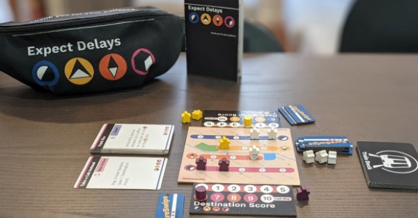 Subway board of Expect Delays. Meeples, cards, and fanny pack.