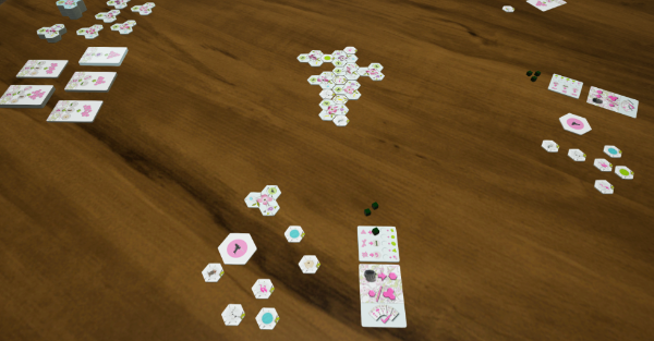 A game of Dogwood in progress, with the tree of tri-hexes and decorations beginning to form