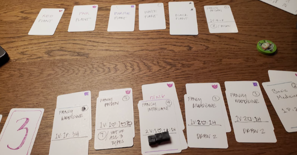 Stacks of playing cards on a wooden table, with a central draft in the middle