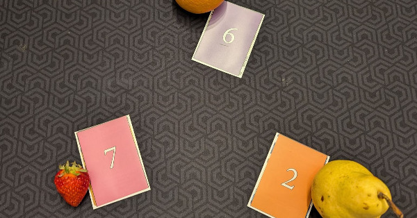 Cards with numbers next paired next to actual fruit