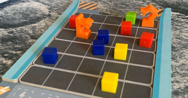 robots and cubes on a cardboard conveyor