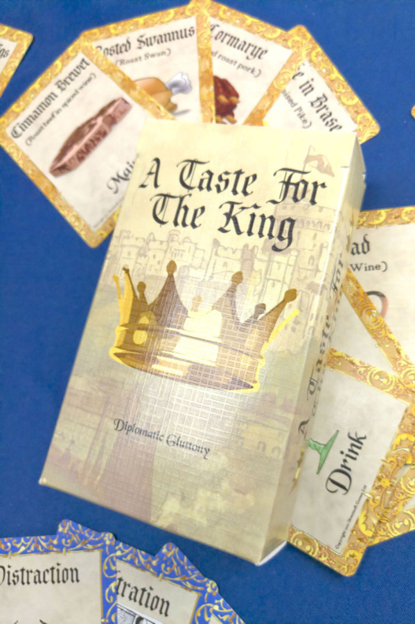 The prototype box lying on a selection of the cards in the game.