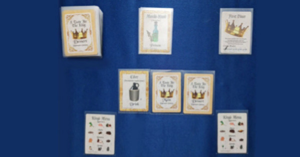 A Taste for the King cards laid out in fans