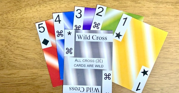 6 multicolored cards, splayed on a wooden background