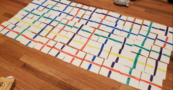 A card game showing a grid of 11 x 5 cards, each with perpendicular strings in different colors.