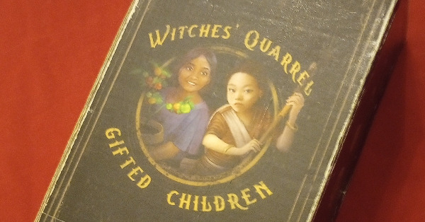 Two kids with words witches' quarrel around them on a game box