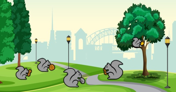 Some squirrels holding nuts in a park
